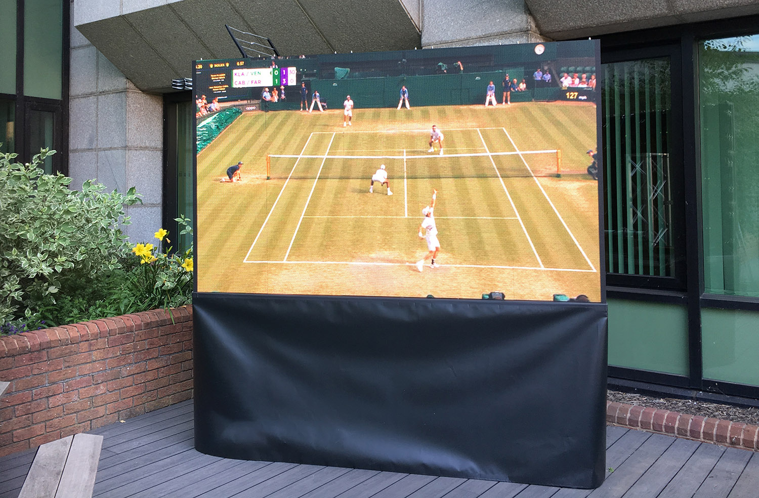 Outdoor Garden TV LED screen showing Wimbledon Tennis